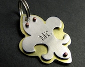 brass and aluminum fleur de lis pet tag