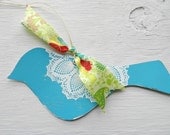 Blue bird with white doily and colorful ribbon ornament for home decor