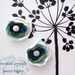 A pair of handmade innocent ivory and something blue flowers filled with a large fresh water pearl and Swarovski crystal. For your wedding, favorite shoes and life.
