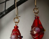 red glass beads with gold accents dangle earrings