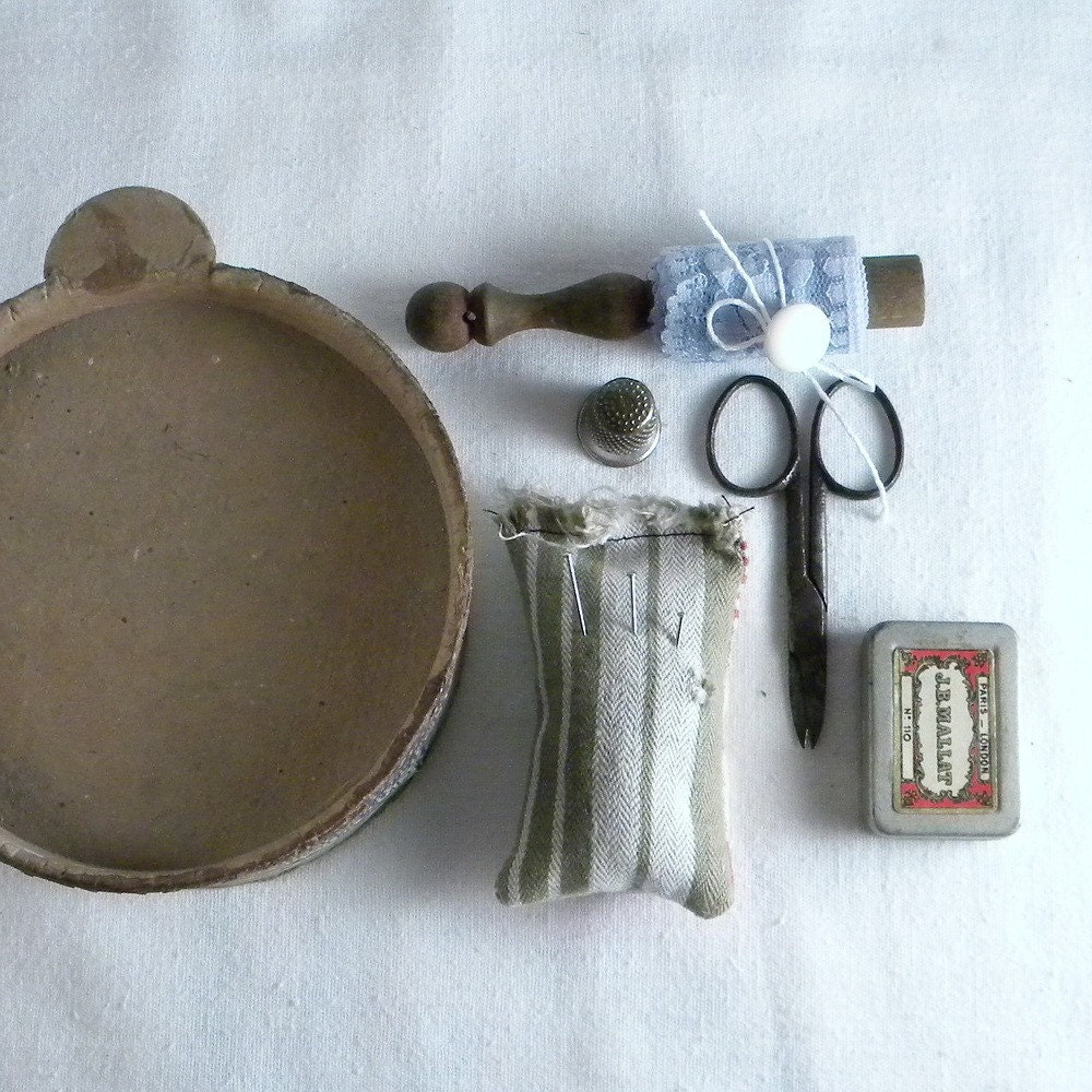 Vintage sewing kit with scissors, lace, lace bobbin, buttons, tin box, pincushion, thimble