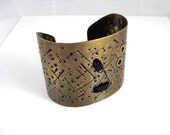 Brass Wide   Bracelet. Cuff. Unique textured  finishing with leather cord.  Brass is the new black by Brand Faina.