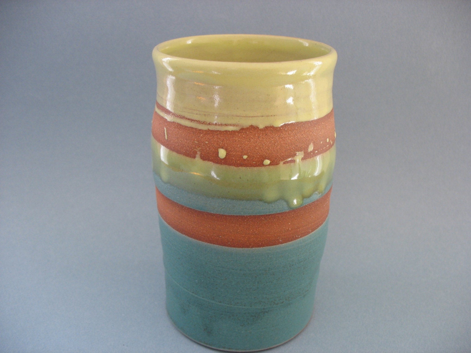Stoneware vase: warm brown clay with matte turquoise and  shiny yellow-green glazes