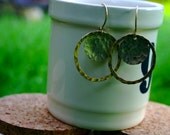 hammered medium silver disc with open gold circle earring.