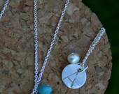 silver initial necklaces.