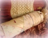 shabby chic victorian bolster pillow made from an antique crazy quilt . satins and silks with hand embroidery