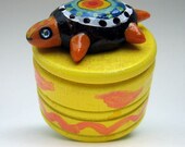 Colorful painted box with turtle on top