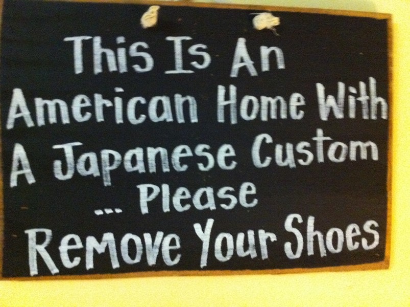 This is an American home with a Japanese custom Please remove your shoes sign wood