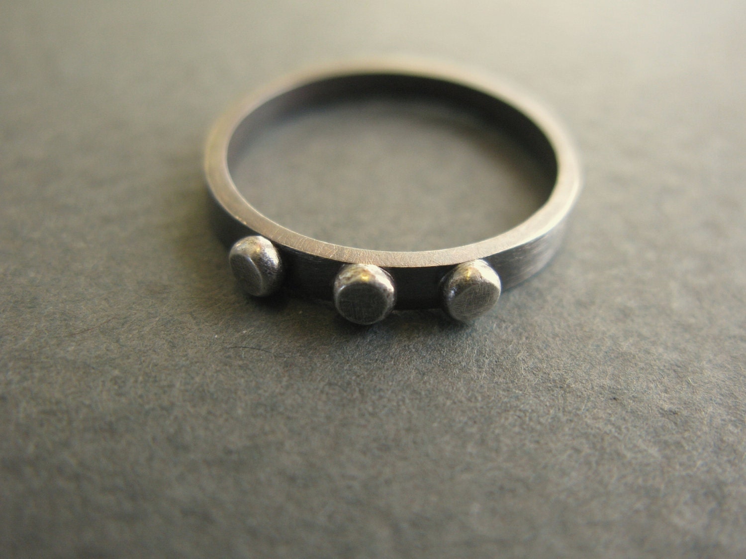Rivet Ring - oxidized silver band with three studs
