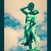 Cymbal Player: fine art photograph print of a green statue of a woman playing music against the blue sky with clouds (Indianapolis)