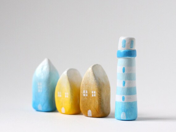 Three little ombré clay houses and a striped lighthouse - light blue, yellow, ochre, white