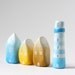 Three little ombré clay houses and a striped lighthouse - light blue, yellow, ochre, white