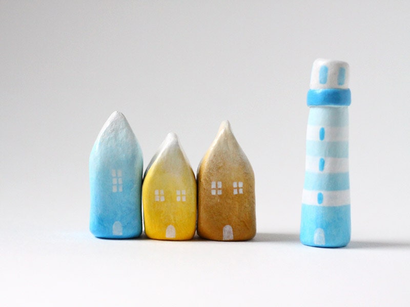Three little ombré clay houses and a striped lighthouse - light blue, yellow, ochre, white