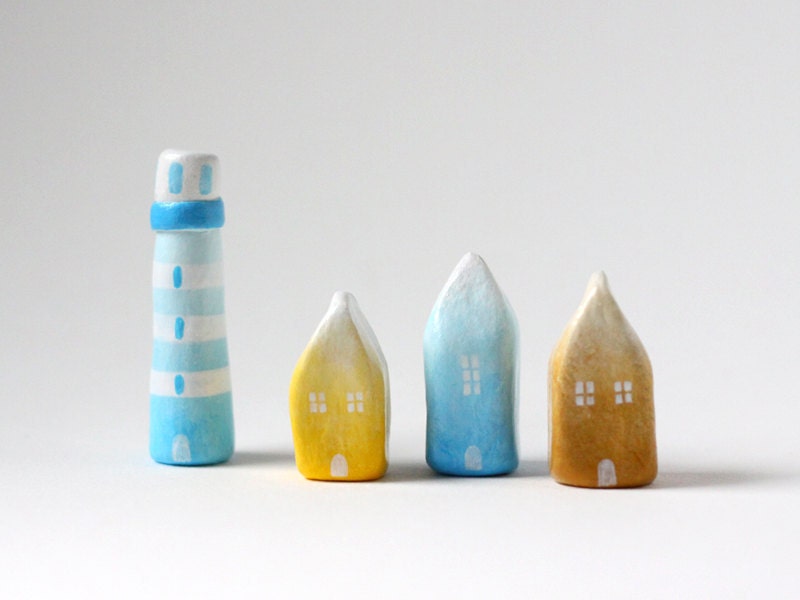 Three little ombré clay houses and a striped lighthouse - light blue, yellow, ochre, white