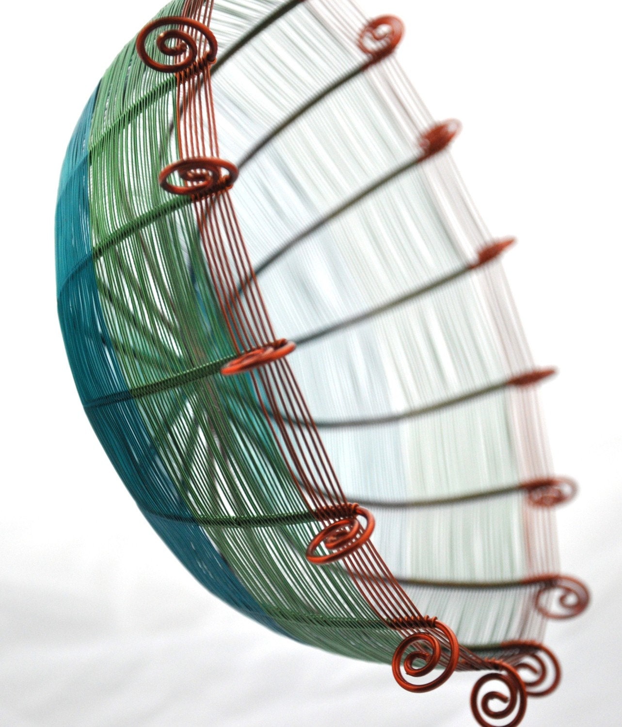 Sixteen sided copper wire basket in teal blue, green, and brown