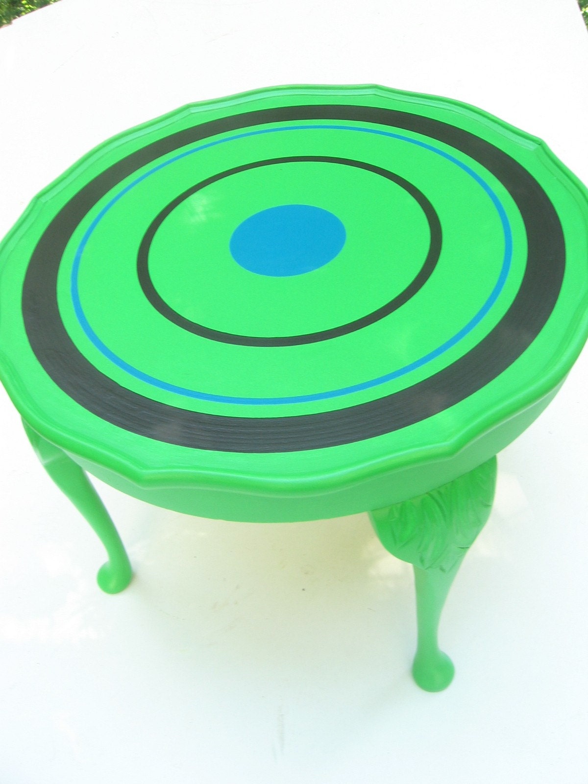 redone modishly, round occasional table -in bright green with rings in dark brown and deep teal