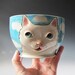 White Cat Yarn Bowl - sculpted kitty against blue sky