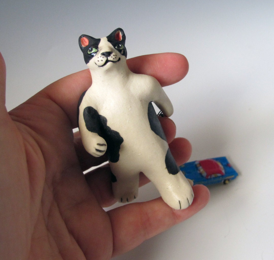 Cat pulling a toy car - hand sculpted ceramic figurine
