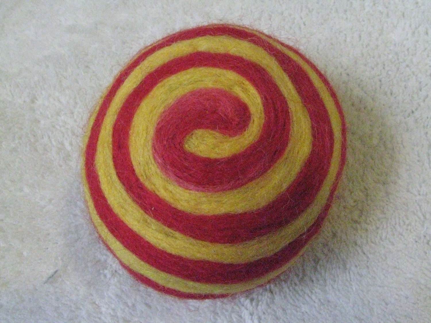 One multi-colored felted pin-cushion, Red and Yellow