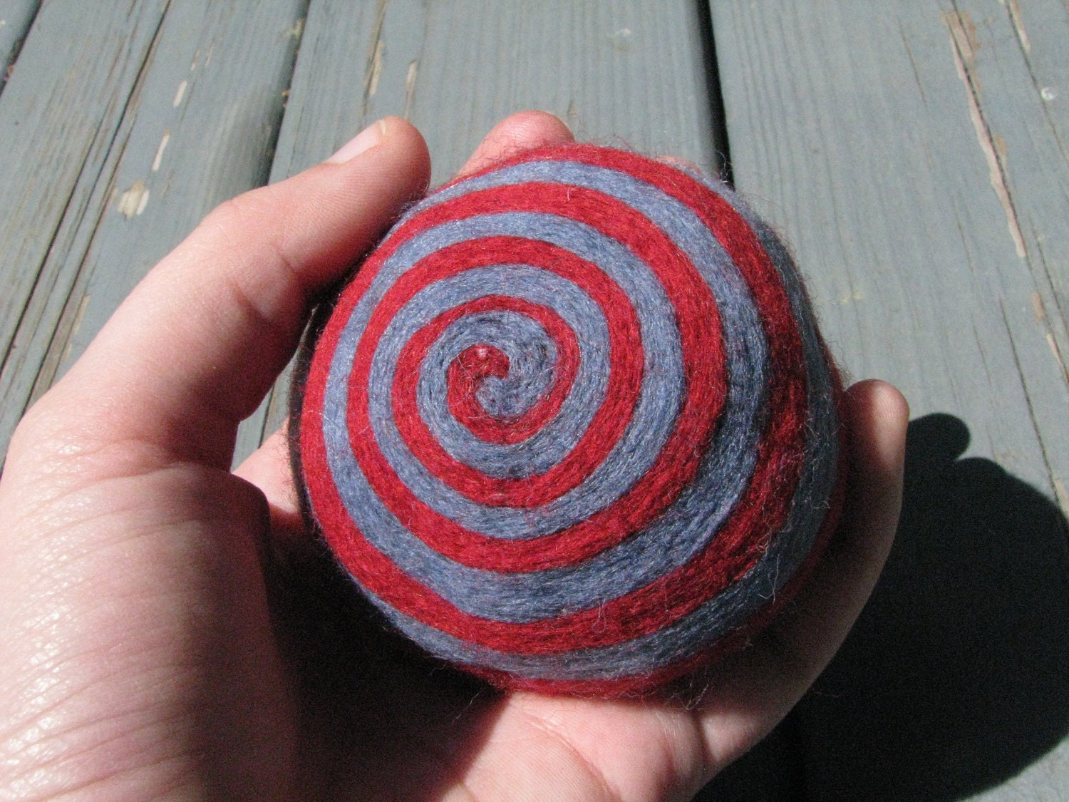 One multi-colored felted pin-cushion, Red and Blue