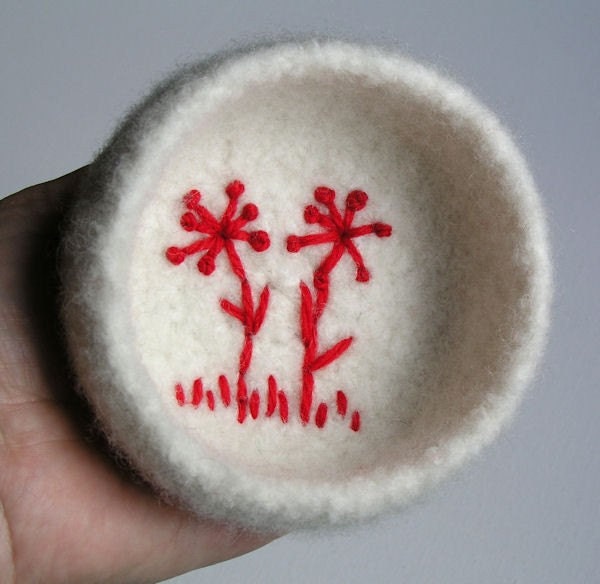 Felted wool bowl with embroidered flowers silhouette in the bottom
