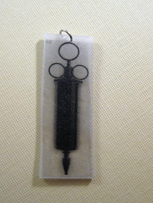 Vintage syringe medical text illustration charm