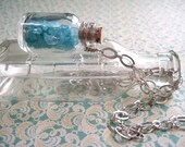 The Second Treasure.  Aquamarine chips in glass bottle on a long silver plated necklace