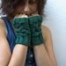 Green fingerless gloves , mittens with an owl pattern