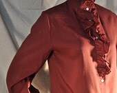 Single Burgundy Glam blouse seeking skinny jeans and silver boots