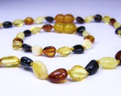 Multicolored amber teething necklace and baby knotted bracelet.