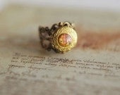 Adjustable vintage locket ring with fiery pink-orange glass opal cabochon - "of Dragons and Knights". Autumn jewelry.