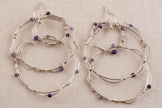Interlocking Twisted Ring Dangles, wire wrapped sterling with iolite gems