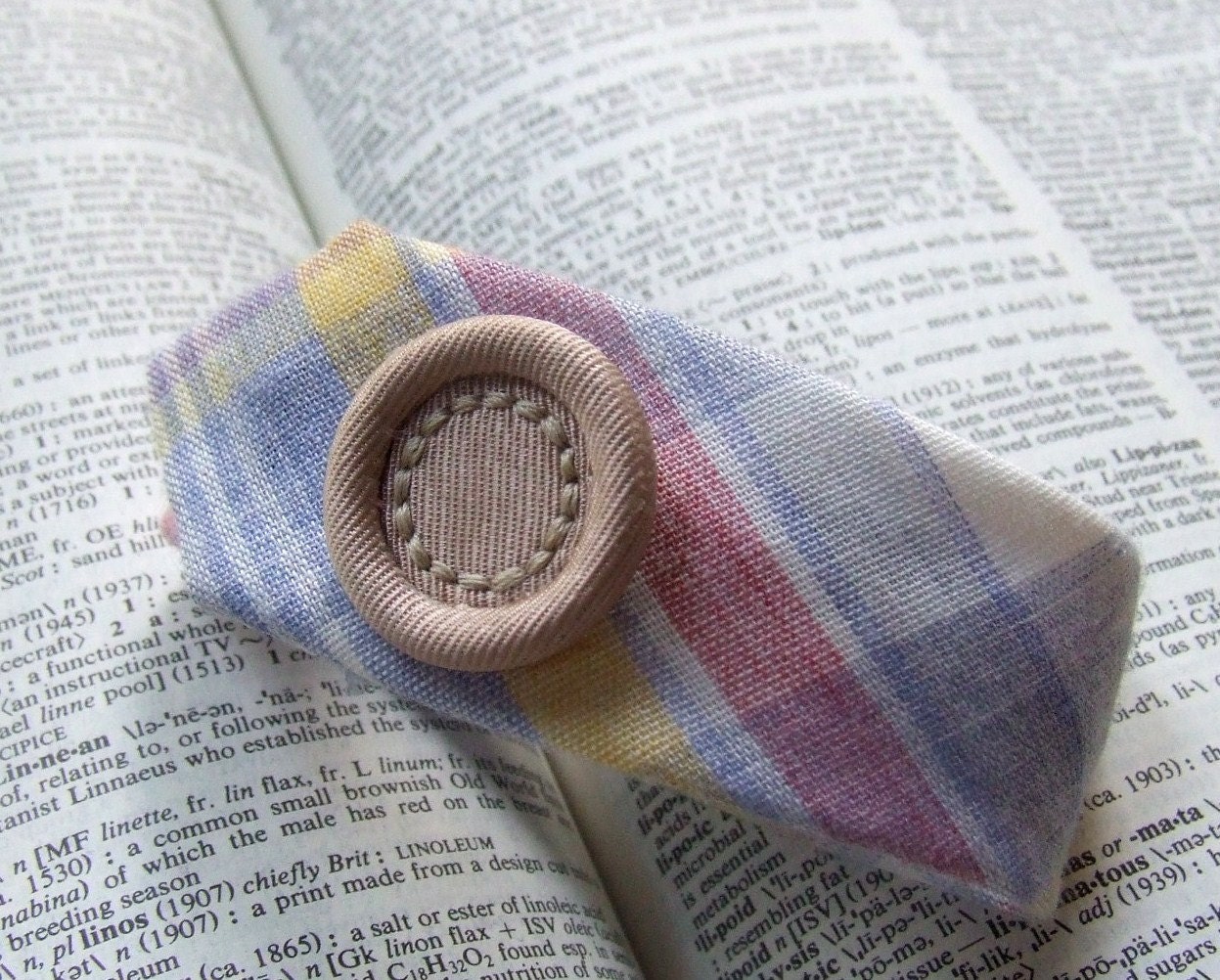 Necktie Wristcuff in pastel madras plaid with upholstered fabric button