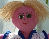 Colorful boy rag doll with blond hair and green eyes