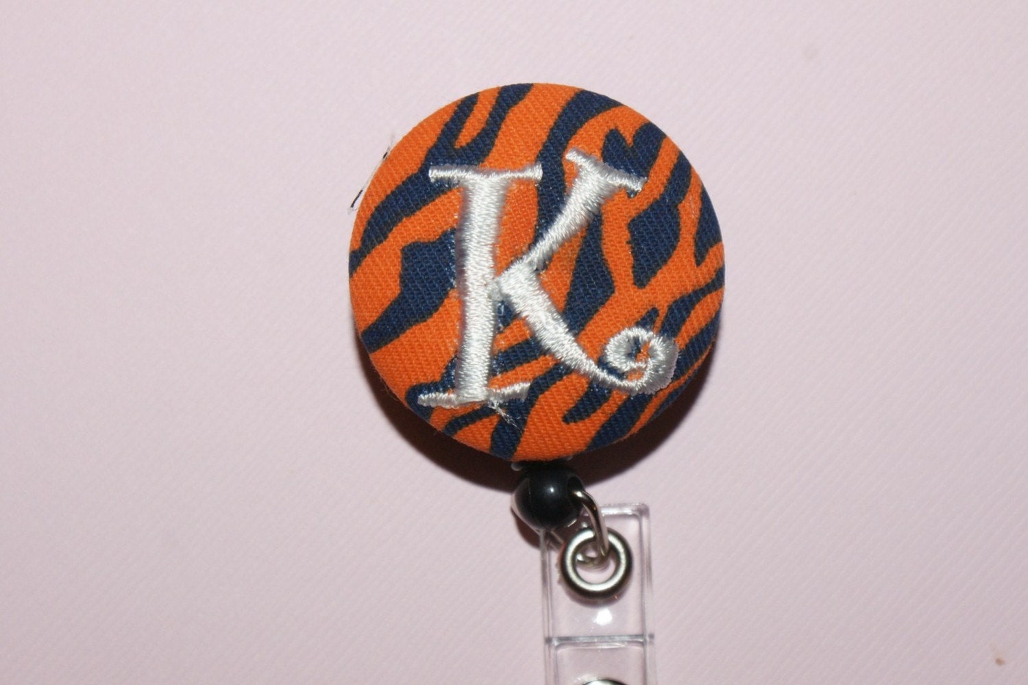 Id Reel monogrammed, U design, fabric, letter and color.  orange and blue tiger stripe
