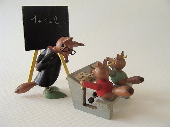 miniature animals perhaps made in germany by erzgebirge a tiny classroom. three handpainted wood foxes.