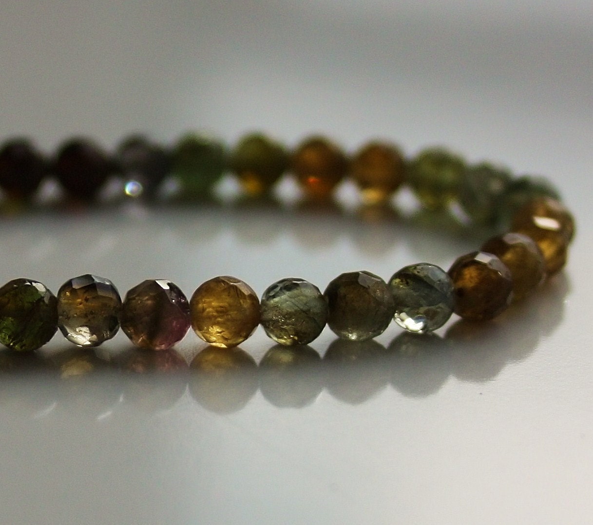 Faceted 4mm. round Tourmaline one of a kind handmade necklace with fishing line and sterling silver spring clasp