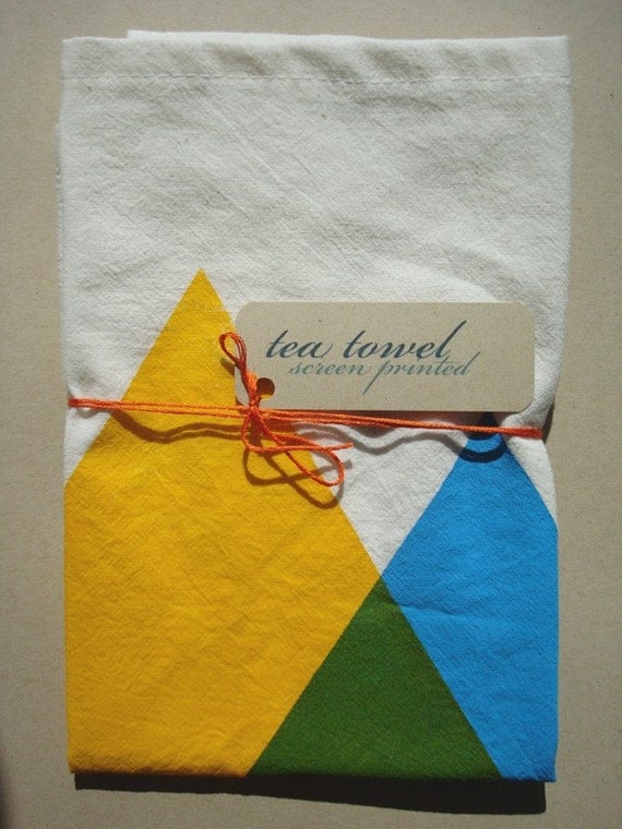 hand screen printed tea towel. blue and yellow makes green triangles.