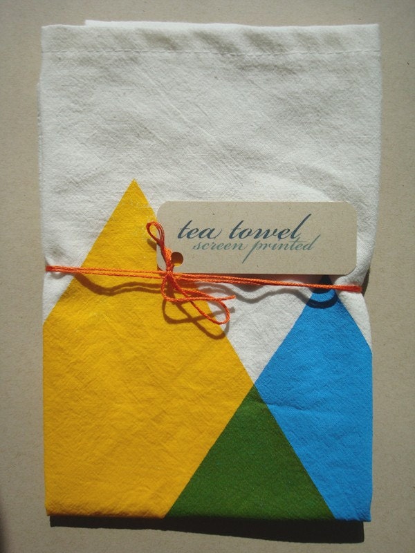 hand screen printed tea towel. blue and yellow makes green triangles.