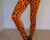 Orange Leggings With A Print Of Small Black Birds