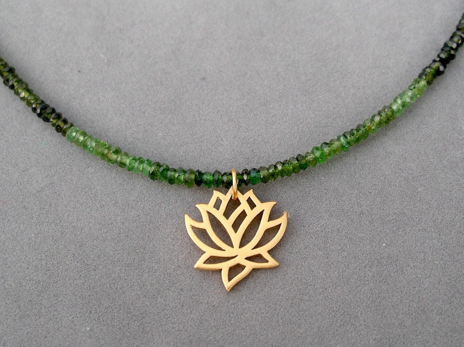 green tourmaline and gold lotus charm necklace