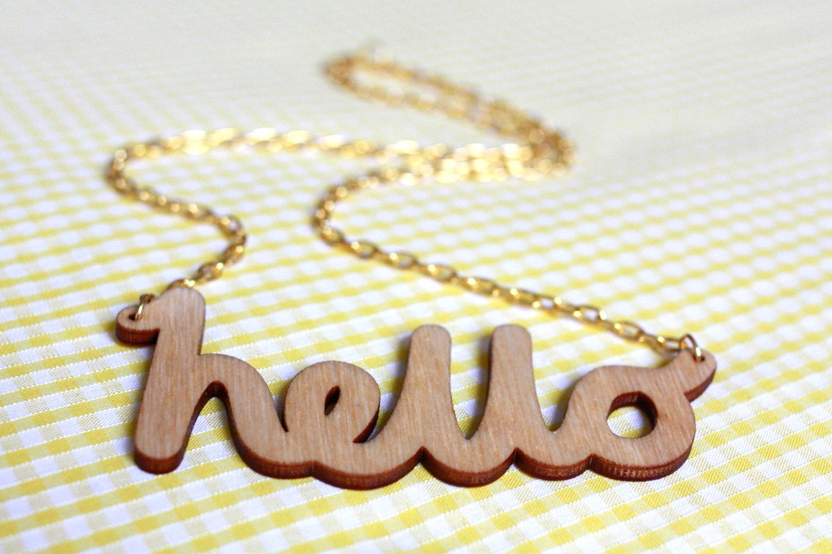 Hello Wooden Necklace. Laser cut in eco friendly birch wood. Gold or silver plated chain.