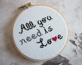 Completed All You Need is Love Cross Stitched in Embroidery Hoop