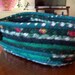 Fabric Coiled Basket in  - Greens and maroon - Oblong shaped - 11 by 3.5 inches