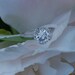 Sparkling brilliant sapphire in a 14k white gold cushion diamond setting