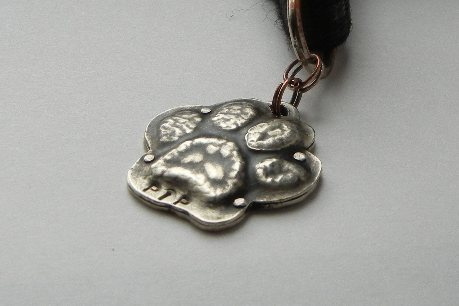 Antiqued nickel silver embossed / repousse paw print dog pet tag id