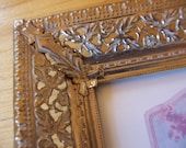goldtone metal frame with coca cola ephemera