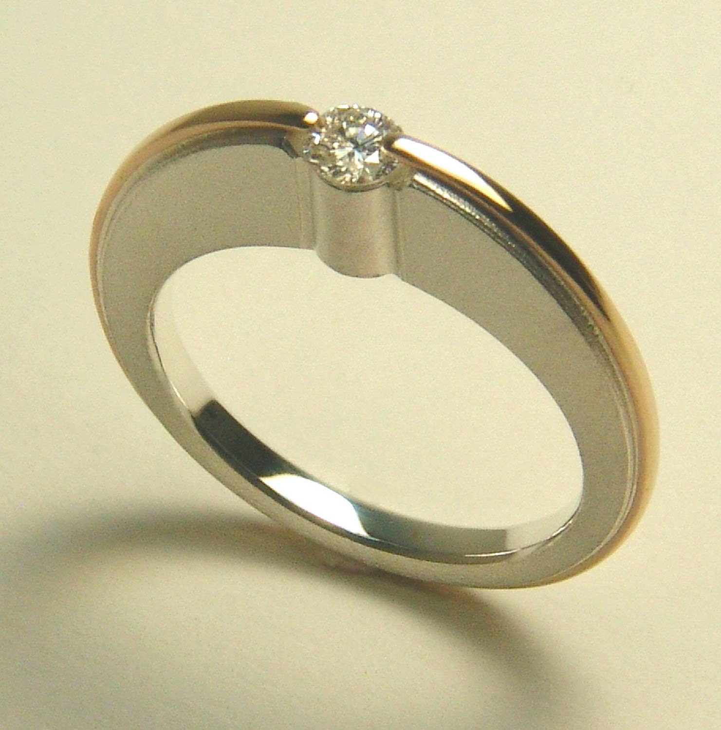 STERLING AND 14 KT. ATOMIC DIAMOND ENGAGEMENT RING