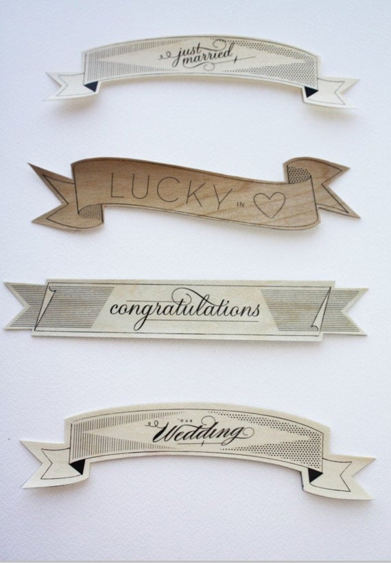 As seen in MARTHA STEWART WEDDINGS wood cake flag banner