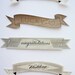 As seen in MARTHA STEWART WEDDINGS wood cake flag banner